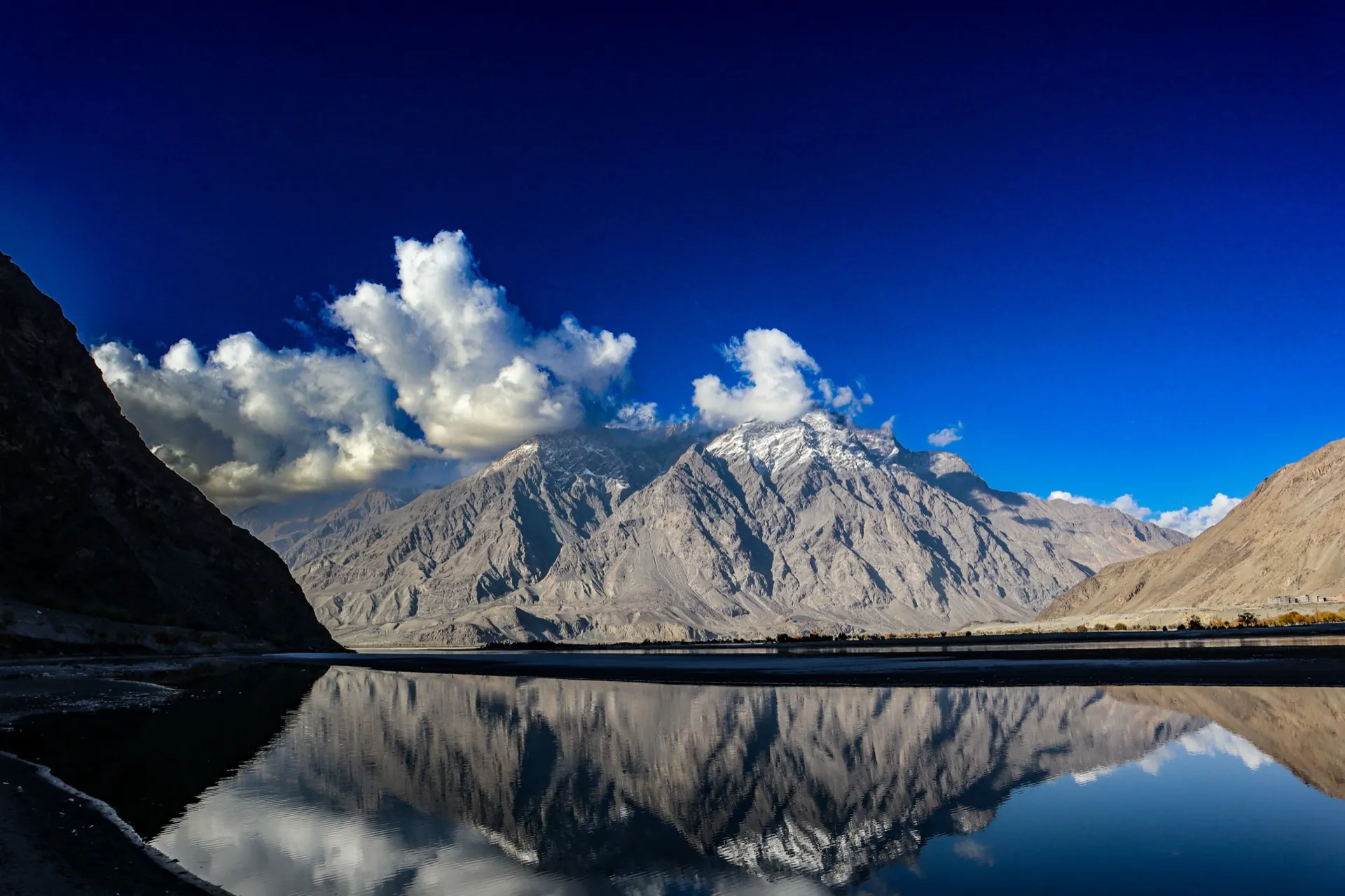 Still water reflecting high mountains near Skardu, Pakistan