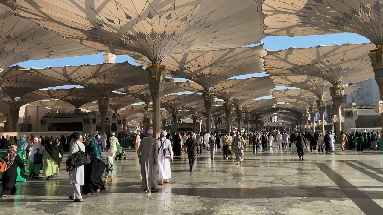 Pilgrims beneath the umbrellas in the courtyard of Al-Masjid an-Nabawi